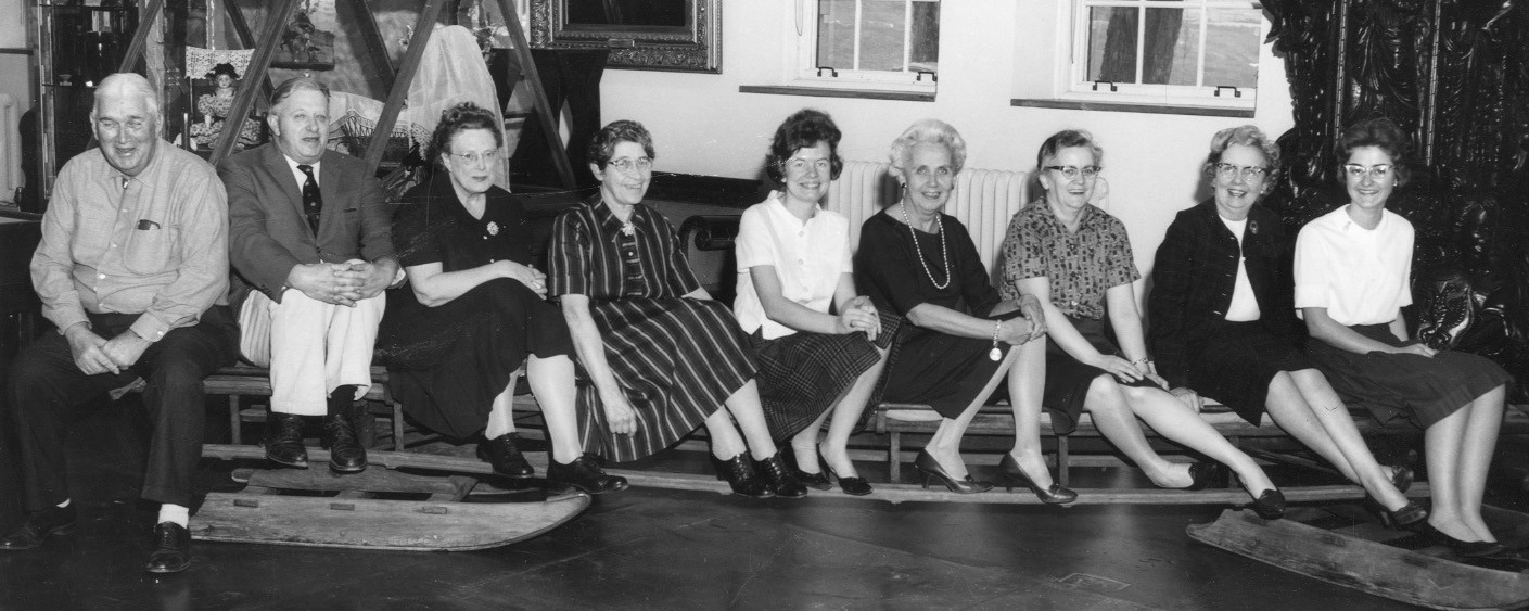 Archival photo of VHS staff sitting on a sled