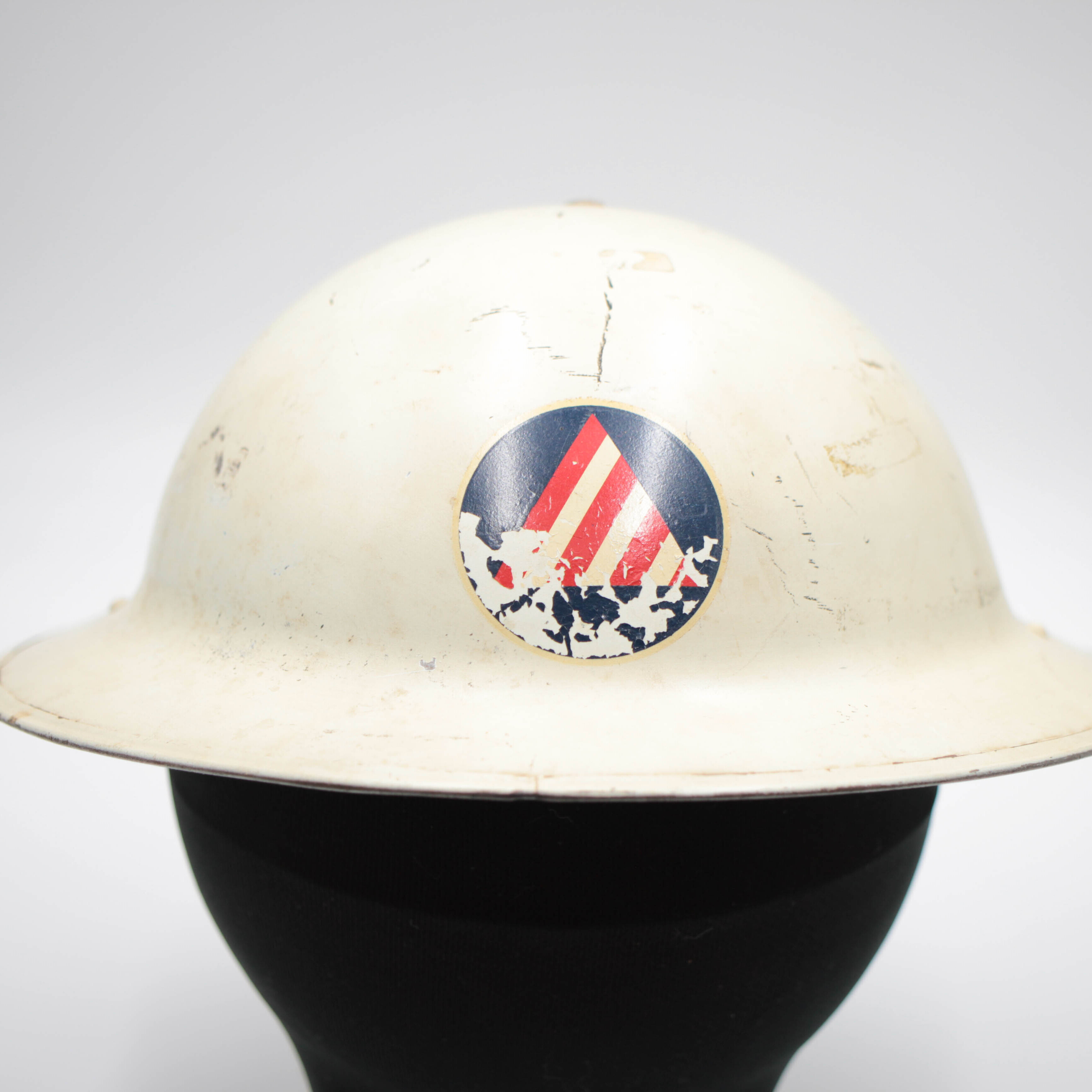 white helmet with triangle symbol