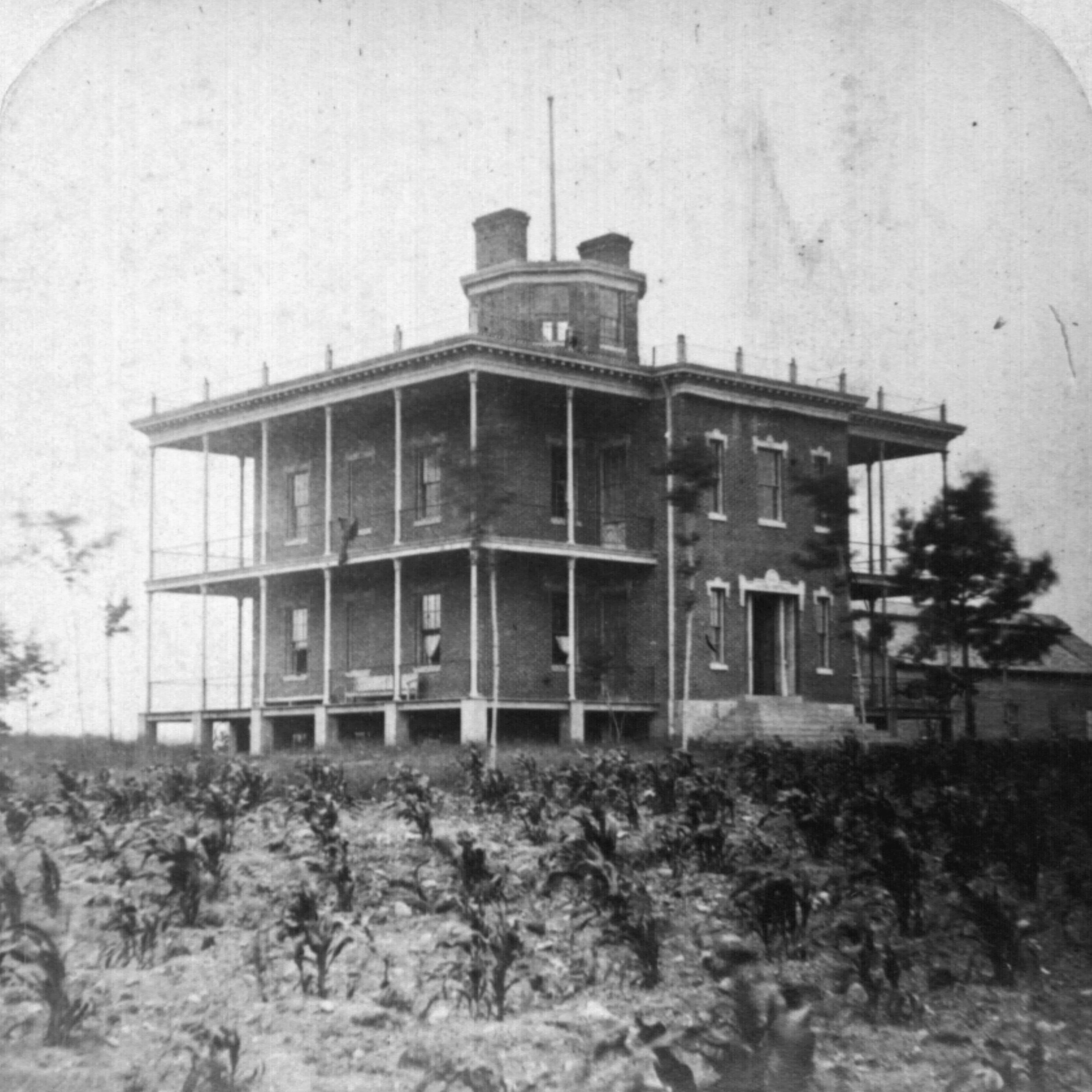 old photo of hospital building with multiple floors and columns