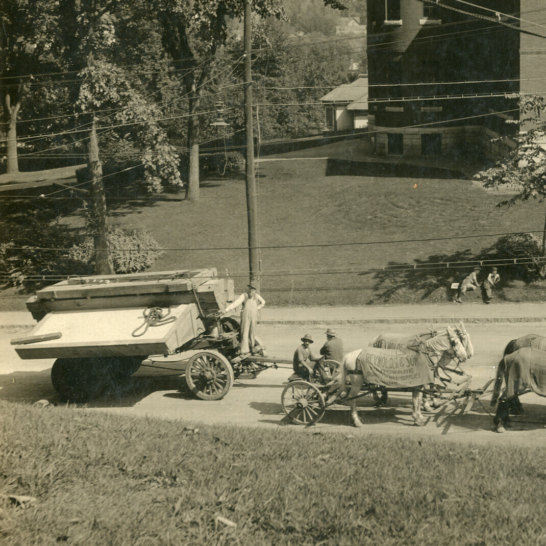 Horses pulling granite on a wagon on Washington Street.