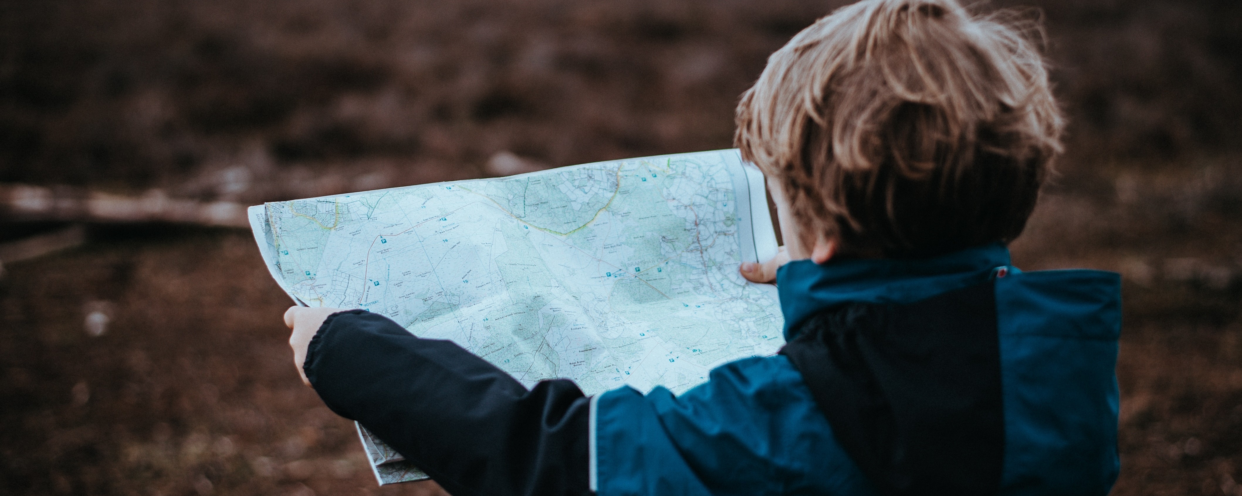 child holding map